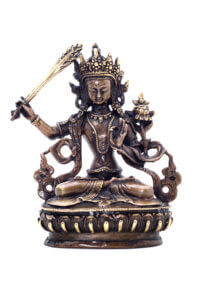 Statuette of Manjushri brandishing sword of wisdom on a white background. Manjushri, Still a Youth. Vajrayana deity.
