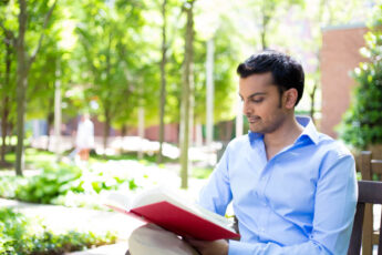 Man Reading in Scenic Park